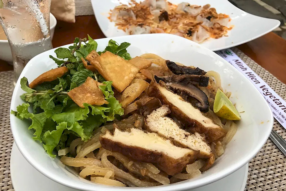 Vegetarian Cao Lau with characteristic chewy noodles, fresh green vegetables, and rich and pure sauce 